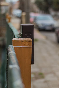 Close-up of padlocks on wooden fence