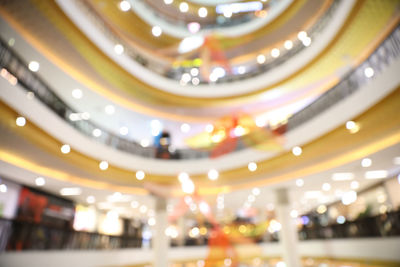 Low angle view of illuminated lights at ceiling