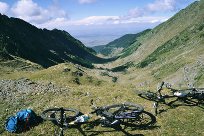 Bicycles on mountains against sky