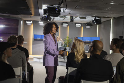 Tv show host interviewing audience member