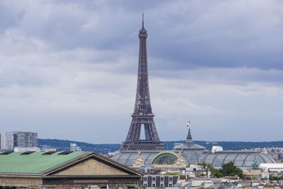 Low angle view of eiffel tower against cloudy sky