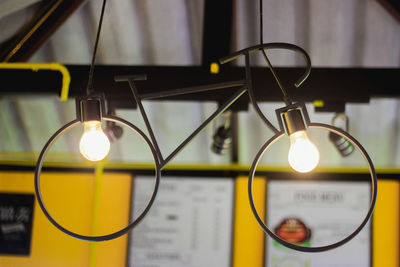 Close-up of illuminated light bulb on table