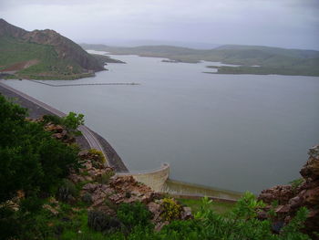 High angle view of river and trees against sky