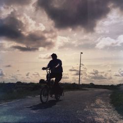 Man riding bicycle on road