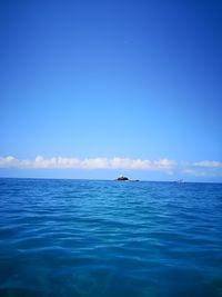 Scenic view of sea against blue sky