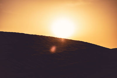 Scenic view of mountain against sky during sunset