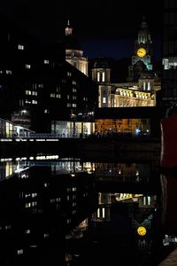 Reflection of illuminated buildings in water at night