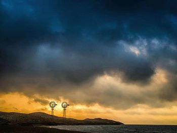 Dramatic sky over landscape during sunset