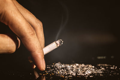 Midsection of person smoking cigarette