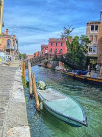 Boats in canal along buildings