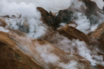 Scenic view of mountains covered with clouds