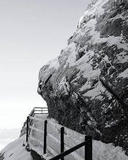 Low angle view of snow covered mountains against clear sky