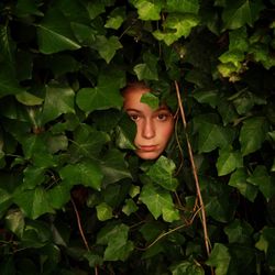 Full length of woman lying on green leaf