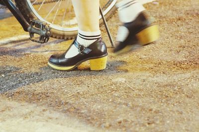 Low section of person standing on tiled floor