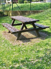 Empty chairs and table in park