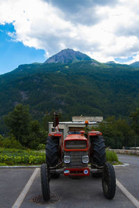 Truck on road against mountains in city