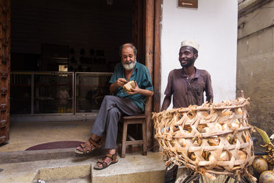 Portrait of a smiling young man holding food