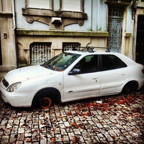 transportation, mode of transport, building exterior, built structure, land vehicle, architecture, car, stationary, metal, day, street, no people, outdoors, parked, old, cobblestone, old-fashioned, parking, in a row, industry