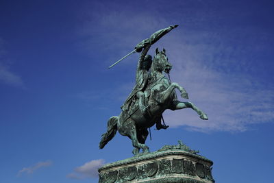 Low angle view of statue against blue sky