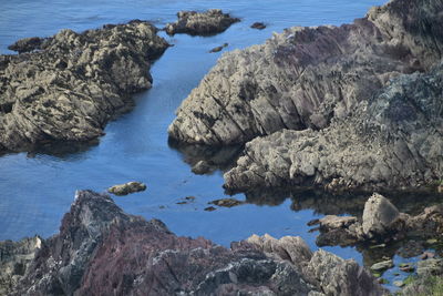 High angle view of rocks by sea