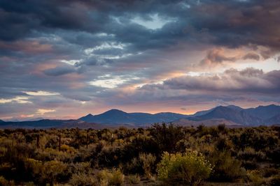 Scenic view of mountains against cloudy sky