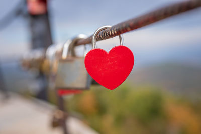 Close-up of love locks hanging on railing