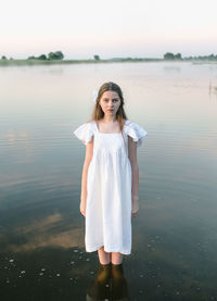 Portrait of girl standing in river