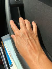 Close-up of hand on book