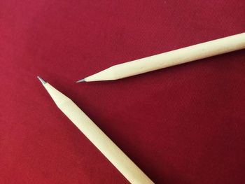 High angle view of colored pencils on paper