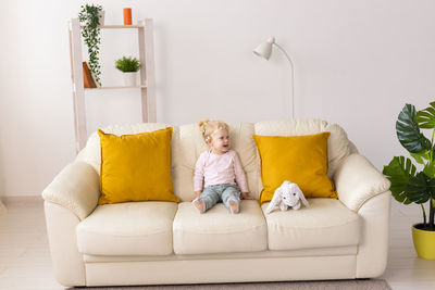 Girl sitting on sofa at home