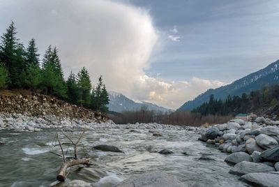 Scenic view of waterfall against sky