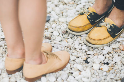 Close up foot of man and woman stand on the stone floor