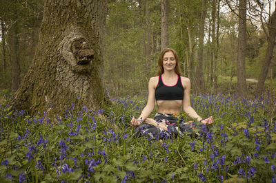 Full length of woman with purple flowers on land