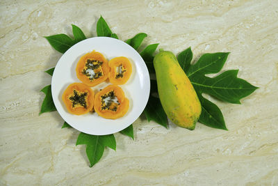 High angle view of fruits in plate on table