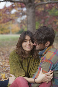 Happy young couple hanging out in a park together