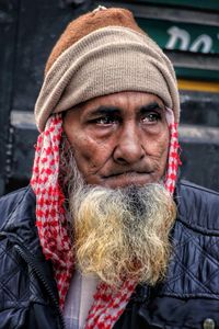 Portrait of a man wearing warm cap on a winter morning stroll in chandni chowk, new delhi, india