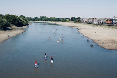 High angle view of people on sea against sky