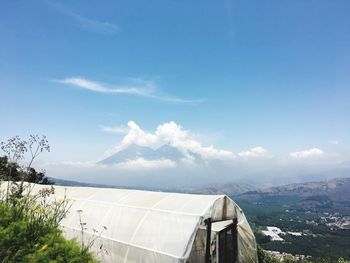 Scenic view of mountains against blue sky