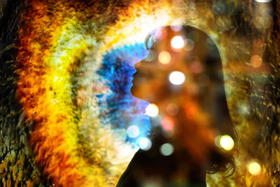 Close-up portrait of illuminated man