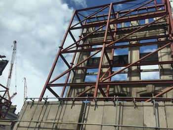 Low angle view of built structure against cloudy sky