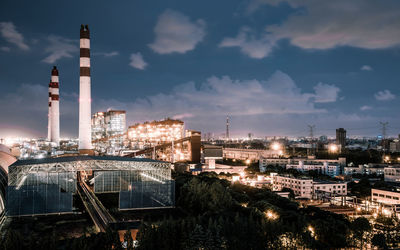 Illuminated city against sky at night