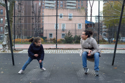 Mom and daughter spending time at the swing