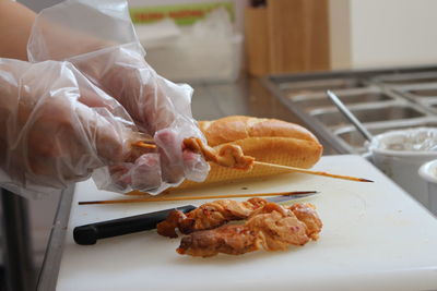 Close-up of hand holding food on table