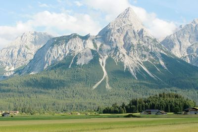 Scenic view of mountains against cloudy sky