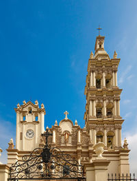 Low angle view of building against blue sky