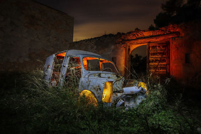 Old abandoned car at night