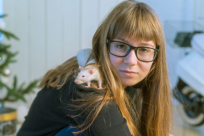 Portrait of smiling girl with rat