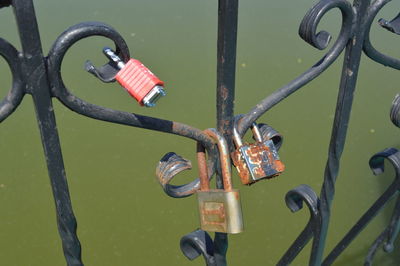 Close-up of padlocks on railing