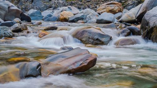 Scenic view of river flowing through rocks