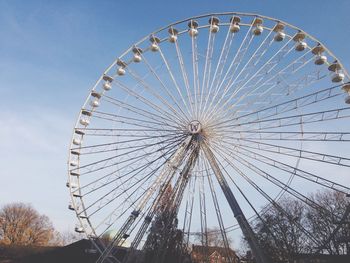 Low angle view of ferris wheel against sky